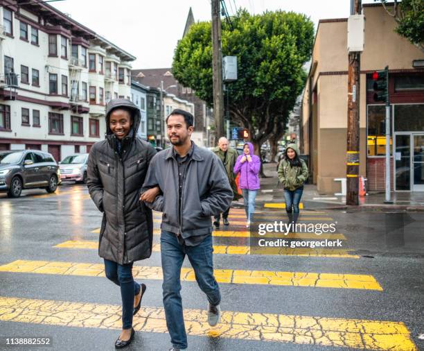 crossing in the rain - pedestrian safety stock pictures, royalty-free photos & images