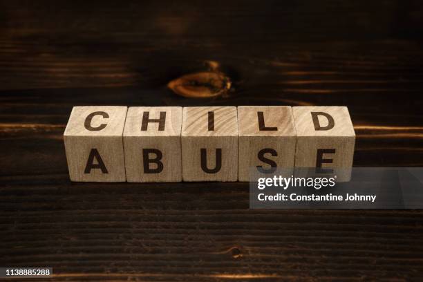 child abuse words on wooden blocks - kindermishandeling stockfoto's en -beelden