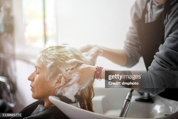 hair washing in hair salon - hairdresser washing hair stock pictures, royalty-free photos & images