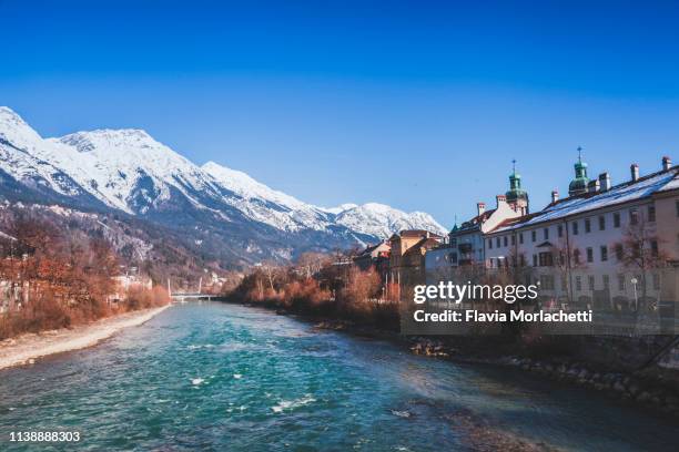 colored buildings along the inn river in innsbruck - innsbruck stock pictures, royalty-free photos & images