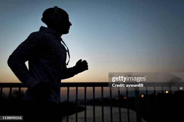 running - athlete silhouette stock pictures, royalty-free photos & images