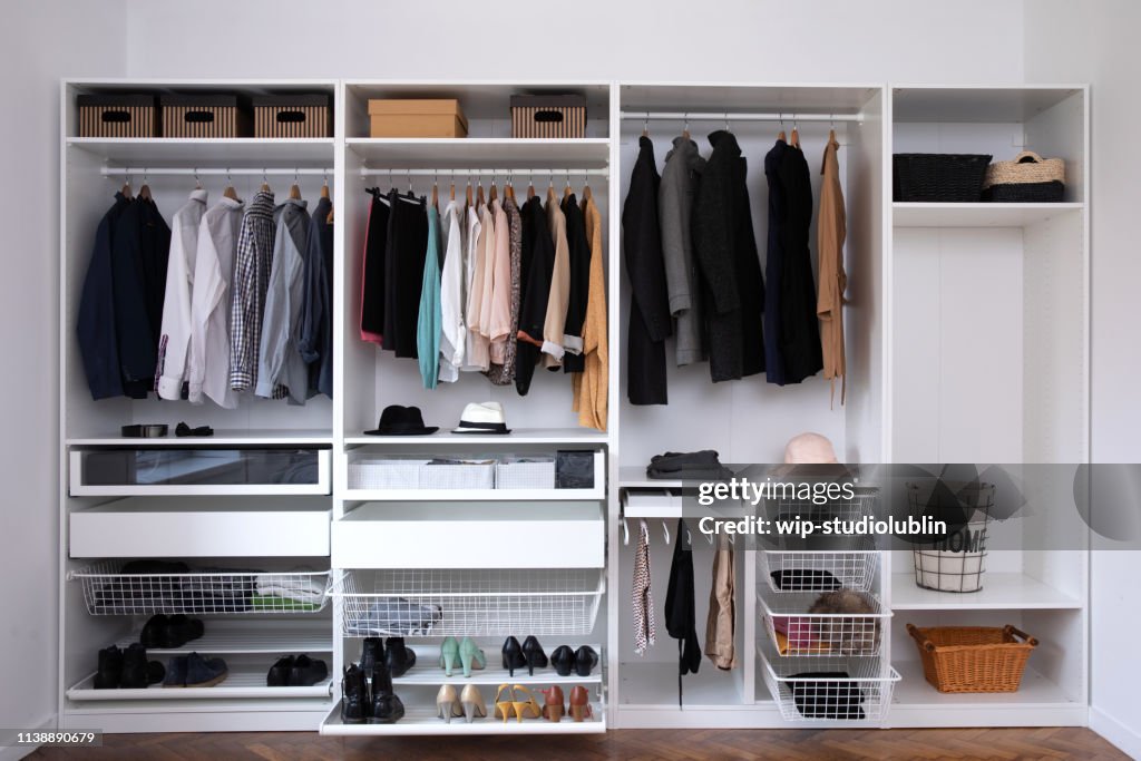 Big wardrobe with different clothes for dressing room