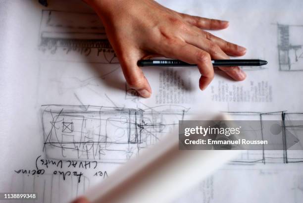 young female architect working on design and construction plans - architectural designer stock pictures, royalty-free photos & images