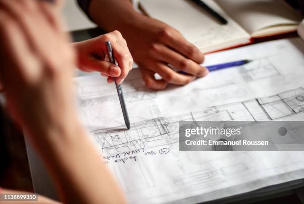 young architects discussing design and construction plans - architect sketching stock-fotos und bilder