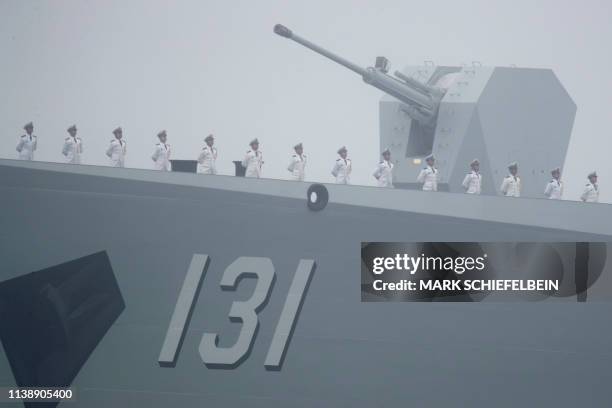 Sailors stand on deck of the type 052D guided missile destroyer Taiyuan of the Chinese People's Liberation Army Navy as it participates in a naval...