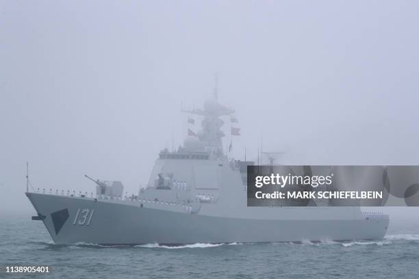 The type 052D guided missile destroyer Taiyuan of the Chinese People's Liberation Army Navy participates in a naval parade to commemorate the 70th...