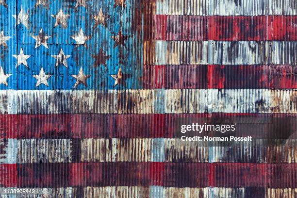 vintage, rusted american flag painted on corrugated wall - american flag texture stock-fotos und bilder