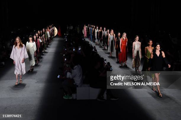 Models present a creation by Lilly Sarti during the Sao Paulo Fashion Week in Sao Paulo, Brazil on April 23, 2019.