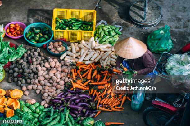 women vendor selling fruits at the market in ho chi minh city - vietnamese food stockfoto's en -beelden