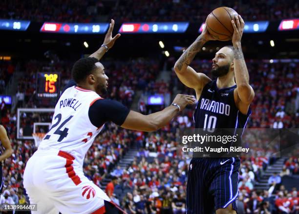 Evan Fournier of the Orlando Magic looks to pass the ball as Norman Powell of the Toronto Raptors defends during Game Five of the first round of the...