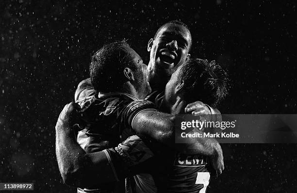 Brett Stewart of the Eagles is congratulated by Will Hopoate and Daly Cherry-Evans after scoring a try during the round nine NRL match between the...