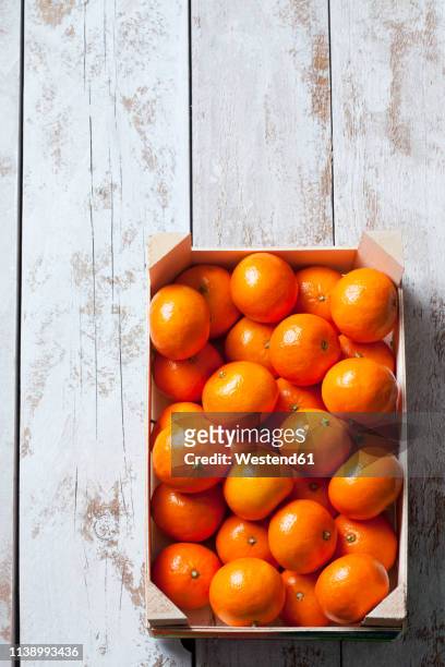 tangerines in crate, on white, wooden background - mandarine stock pictures, royalty-free photos & images