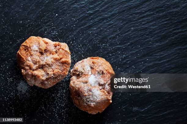 choux pastry crullers on black slate - choux pastry stock pictures, royalty-free photos & images