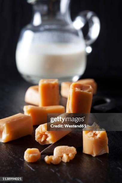 fresh cream toffees and a carafe of cream - toffee stock pictures, royalty-free photos & images