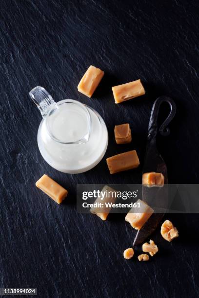 fresh cream toffees and a carafe of cream - dulce de azúcar y mantequilla fotografías e imágenes de stock