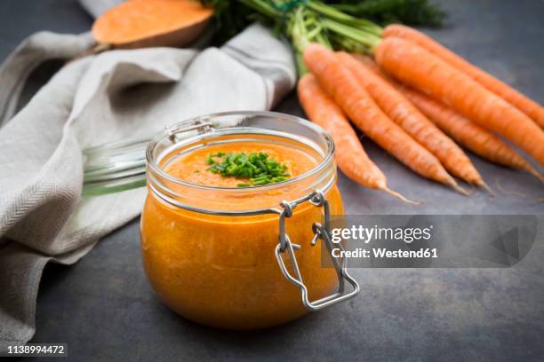 glass of sweet potato carrot soup garnished with chives - mashed sweet potato imagens e fotografias de stock