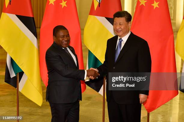 Mozambique's president Filipe Nyusi shakes hands with Chinese president Xi Jinping before their meeting at the Great Hall of the People in Beijing,...