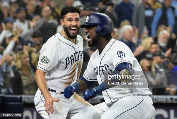 Franmil Reyes of the San Diego Padres celebrates with Eric Hosmer after hitting a solo home run during the sixth inning of a baseball game against...