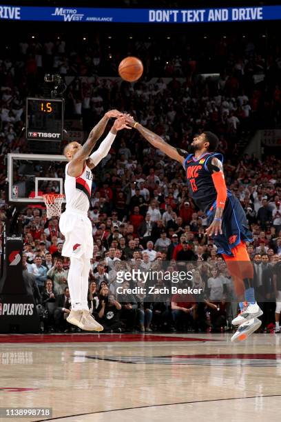 Damian Lillard of the Portland Trail Blazers shoots the three point basket over Paul George of the Oklahoma City Thunder to win the game as time...