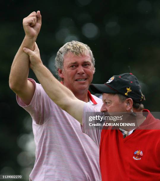 European Ryder Cup player Darren Clarke celebrates with Captain Ian Woosnam on the 16th hole after playing against Zach Johnson of the United States...