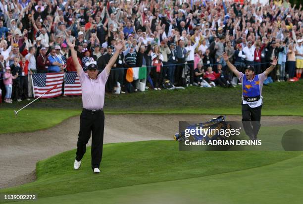 European Ryder Cup player Darren Clarke celebrates after making a 110 ft putt on the 12th green as he plays against Zach Johnson of the United States...