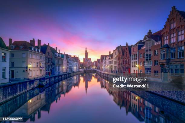 belgium, bruges, row of houses at canal by twilight - bruges belgium stock pictures, royalty-free photos & images