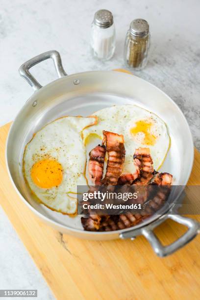 fried eggs and bacon in pan - engelsk frukost bildbanksfoton och bilder