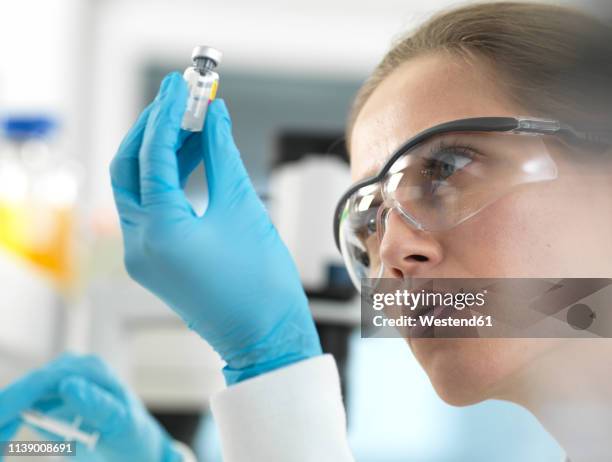 doctor preparing a vaccine for a patient - vaccine development stock pictures, royalty-free photos & images