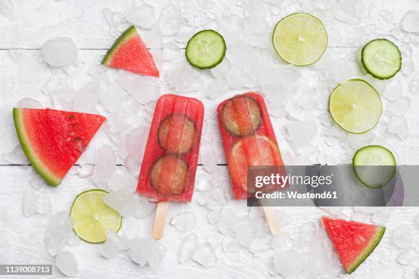 homemade watermelon cucumber ice lollies on white ground - ghiaccio tritato foto e immagini stock