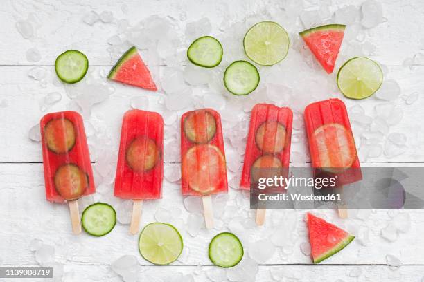 homemade watermelon cucumber ice lollies on white ground - ghiaccio tritato foto e immagini stock