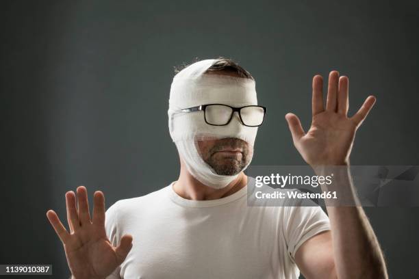 man with gauze bandage, beauty craze - head bandage stock pictures, royalty-free photos & images