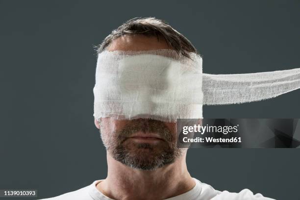 man with gauze bandage, beauty craze - head bandage stock pictures, royalty-free photos & images