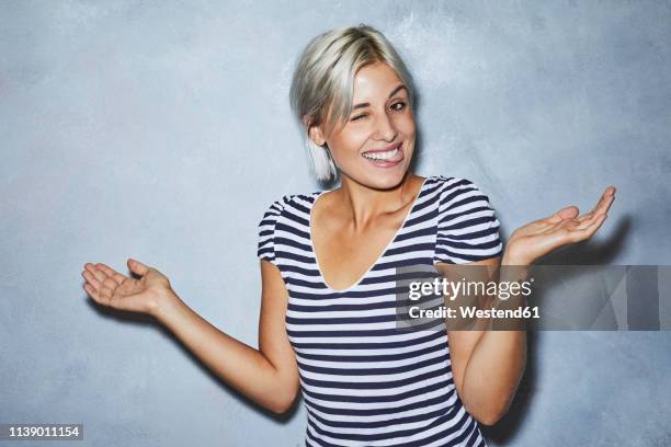 cheaky young woman making funny faces - mischief woman stock pictures, royalty-free photos & images