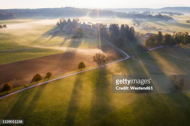 germany, bavaria, ried near dietramszell, ground fog at sunrise, drone view - village stock-fotos und bilder