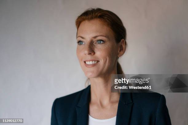 portrait of smiling businesswoman looking sideways - at a glance foto e immagini stock
