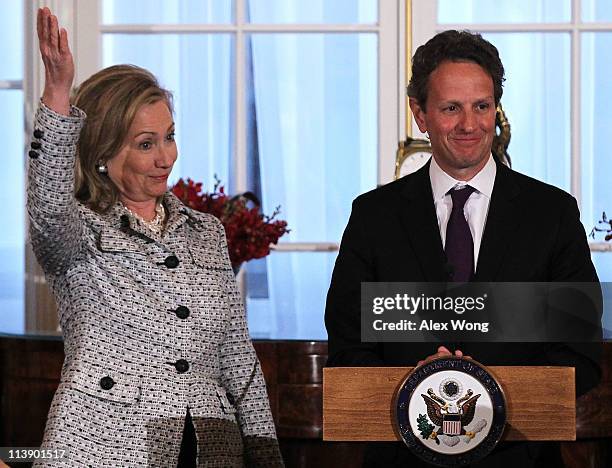 Secretary of the Treasury Timothy Geithner speaks as Secretary of State Hillary Clinton reacts during a dinner of the 2011 U.S.-China Strategic and...