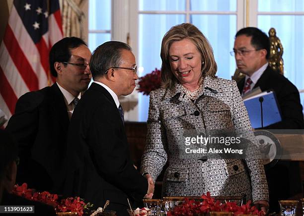 Secretary of State Hillary Clinton shakes hands with Chinese State Councilor Dai Bingguo during a dinner of the 2011 U.S.-China Strategic and...