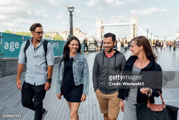uk, london, happy friends walking near   tower bridge - london 2018 day 4 bildbanksfoton och bilder