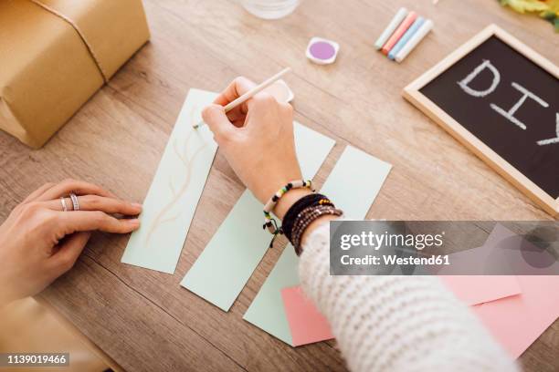 young woman doing crafts with watercolour in her studio - diy craft stock pictures, royalty-free photos & images