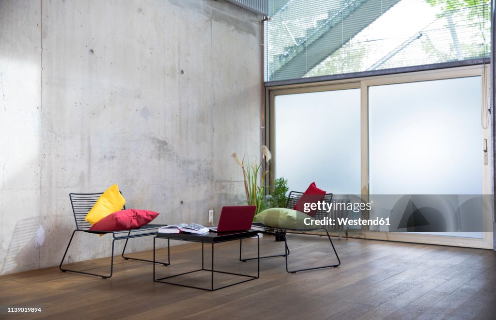 Sitting area in a loft at concrete wall