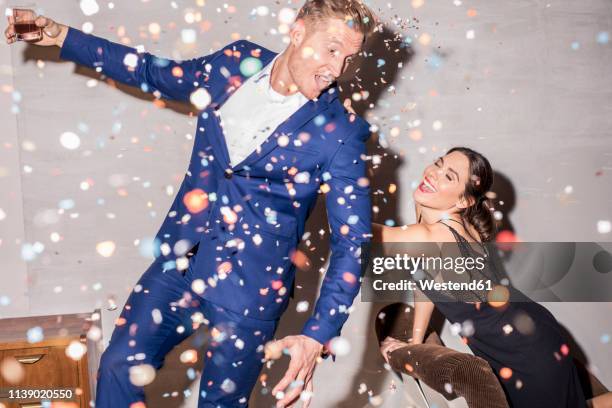 young couple having fun at a party - blauw pak stockfoto's en -beelden
