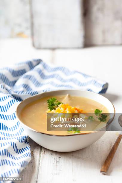 bowl of homemade chicken stock with potatoes, carrots and parsley - bowl of soup stockfoto's en -beelden