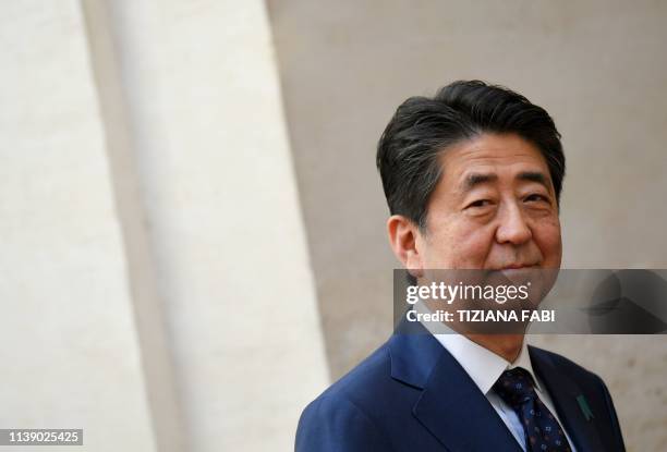 Japan's Prime Minister Shinzo Abe arrives at the Palazzo Chigi to attend a meeting with Italy's Prime Minister, on April 24, 2019 in Rome, during a...