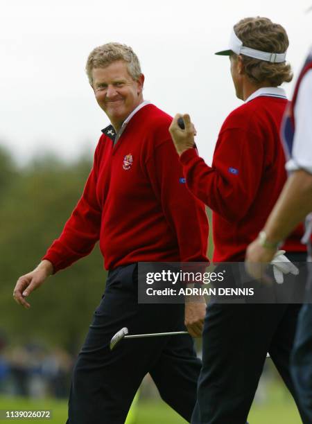 European players Colin Montgomerie smiles to his partner Bernhard Langer after the pair won the 4th hole during the match against Phil Mickelson and...