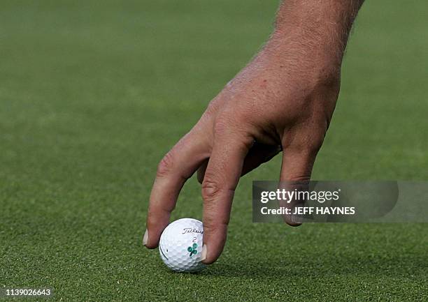 European Ryder Cup golfer Darren Clarke places his ball on a green as he and partner Lee Westwood challenge Tiger Woods and Jim Furyk of the United...