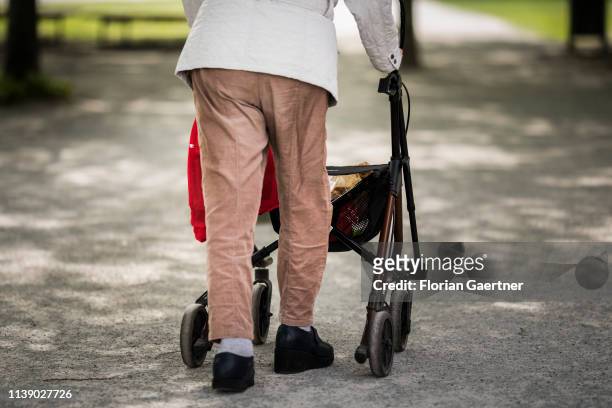 An old woman is pictured with a wheeled walker on April 24, 2019 in Berlin, Germany.