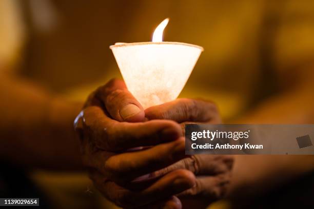 Occupy co-founder Reverend Chu Yiu-ming holds a candle during a vigil to support the pro-democracy leaders who were found guilty over the Hong Kong's...