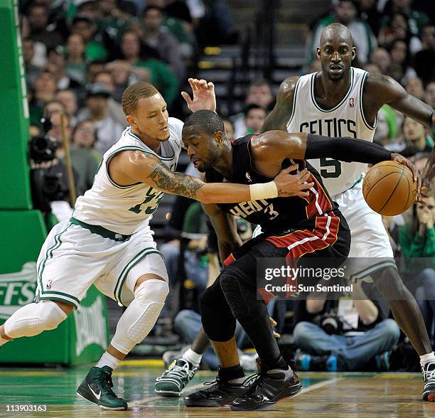 Boston Celtic guard Delonte West reaches in on Miami Heat guard Dwyane Wade in the fourth quarter during Game 4 of their NBA Eastern Conference...