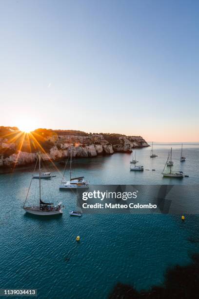 sunrise over yachts in the mediterranean sea, spain - twilights fotografías e imágenes de stock