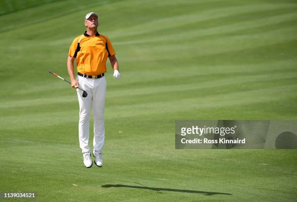 Robert Karlsson of Sweden jumps to check his line after playing his second shot on the 4th hole during round two of the Hero Indian Open at the DLF...